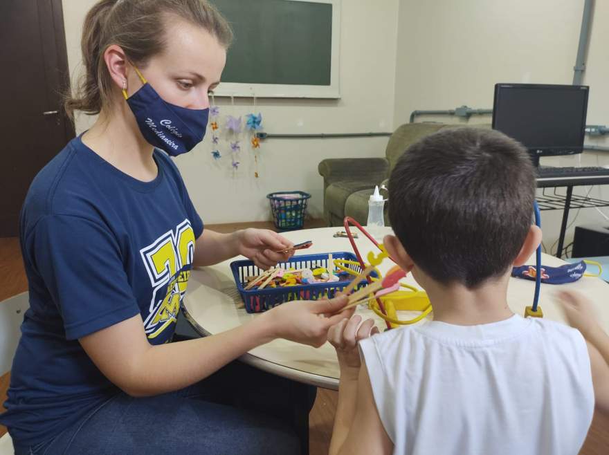 : Professora Gabriela utiliza recursos pedagógicos para auxiliar individualmente cada criança.